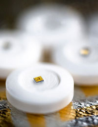 Photo of Proteus Biomedical's digital pills - white pill with tiny chip embedded on top